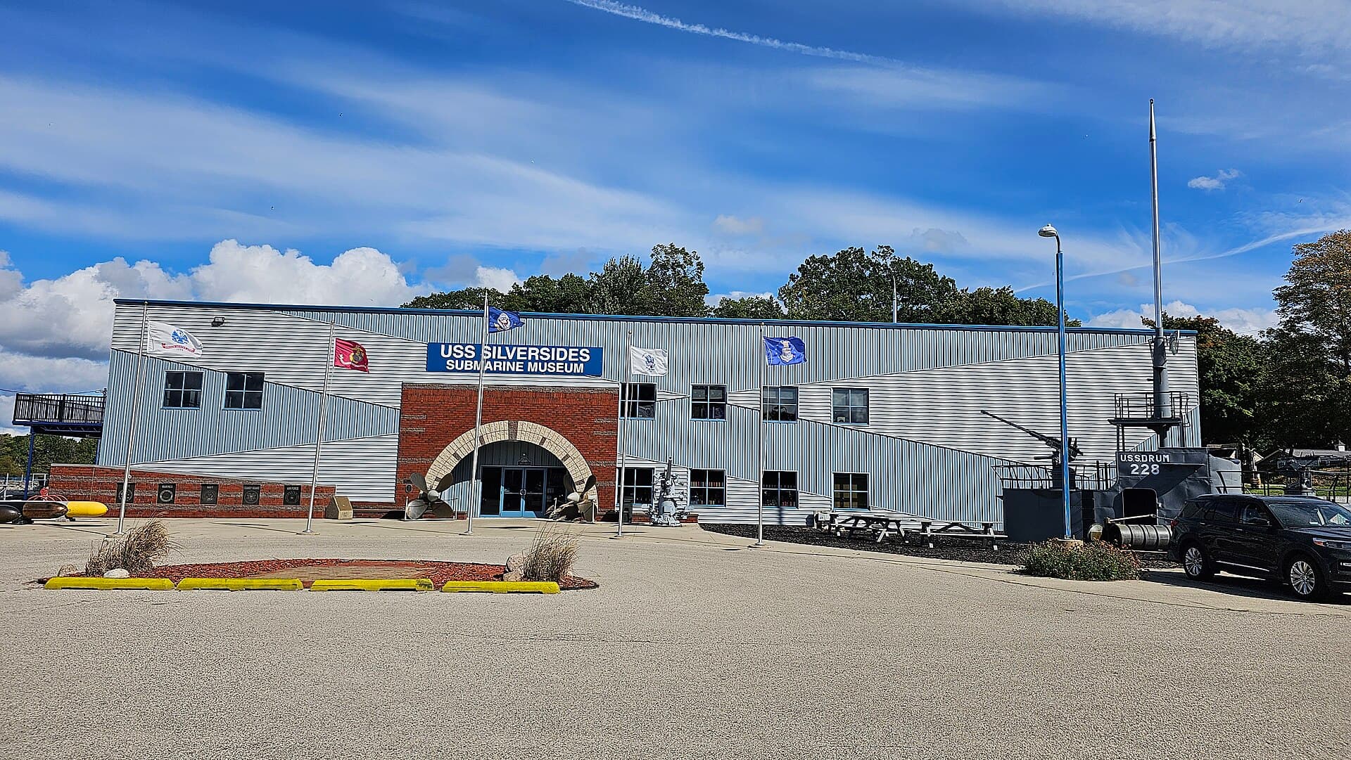 The USS Silversides Submarine Museum building beside the Muskegon channel under a blue sky